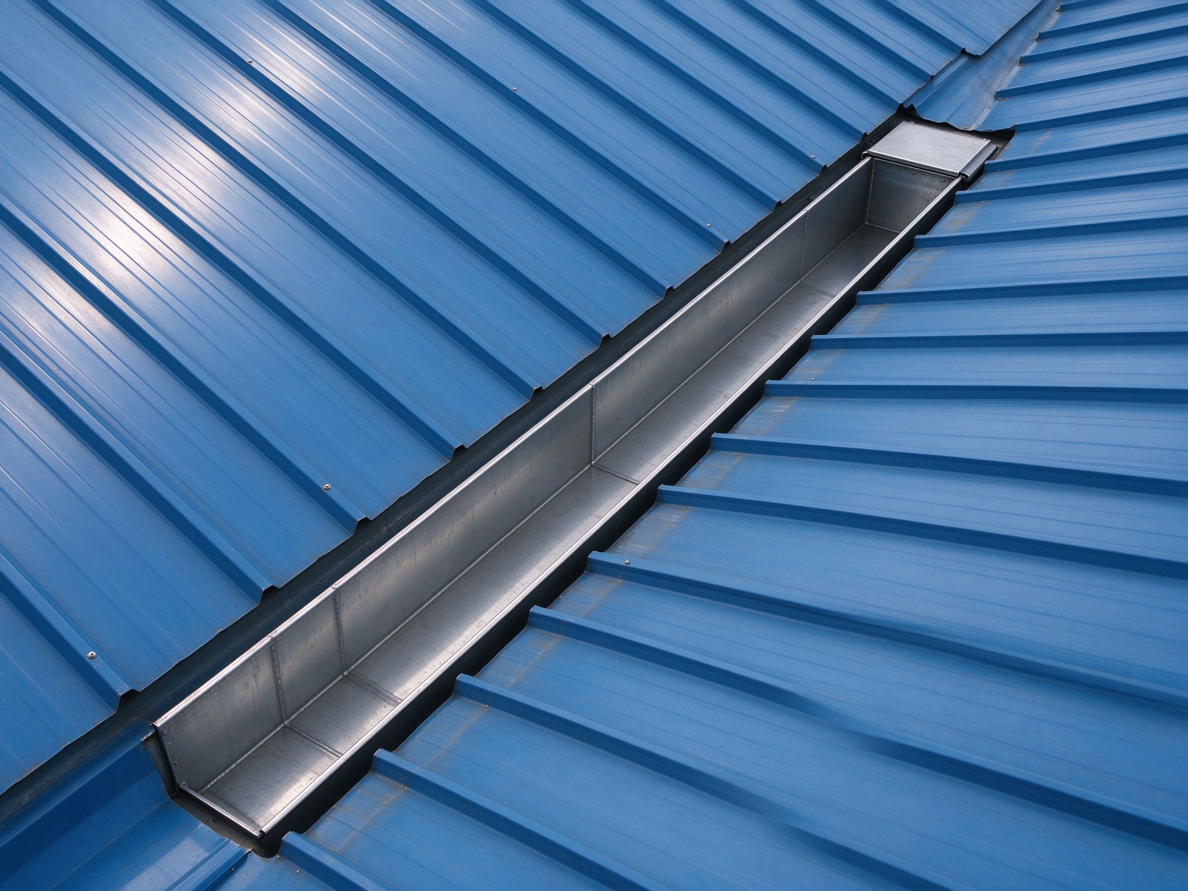 Internal box gutter at the valley between two roof slopes (illustrative concept image)