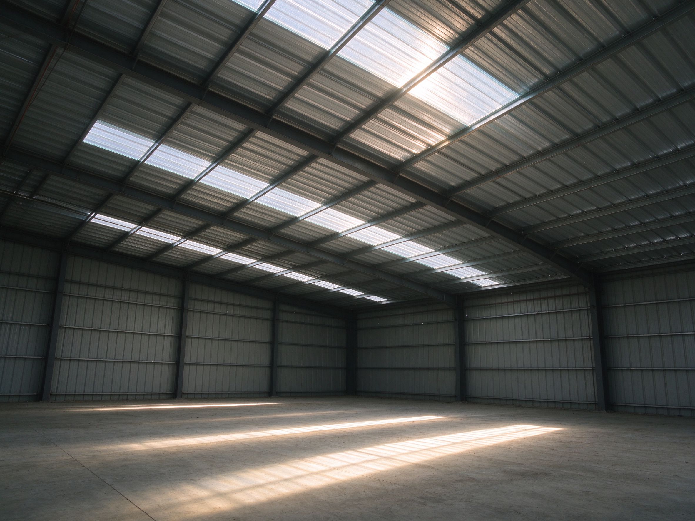 Natural light through daylighting panels in a steel building interior (illustrative concept image)