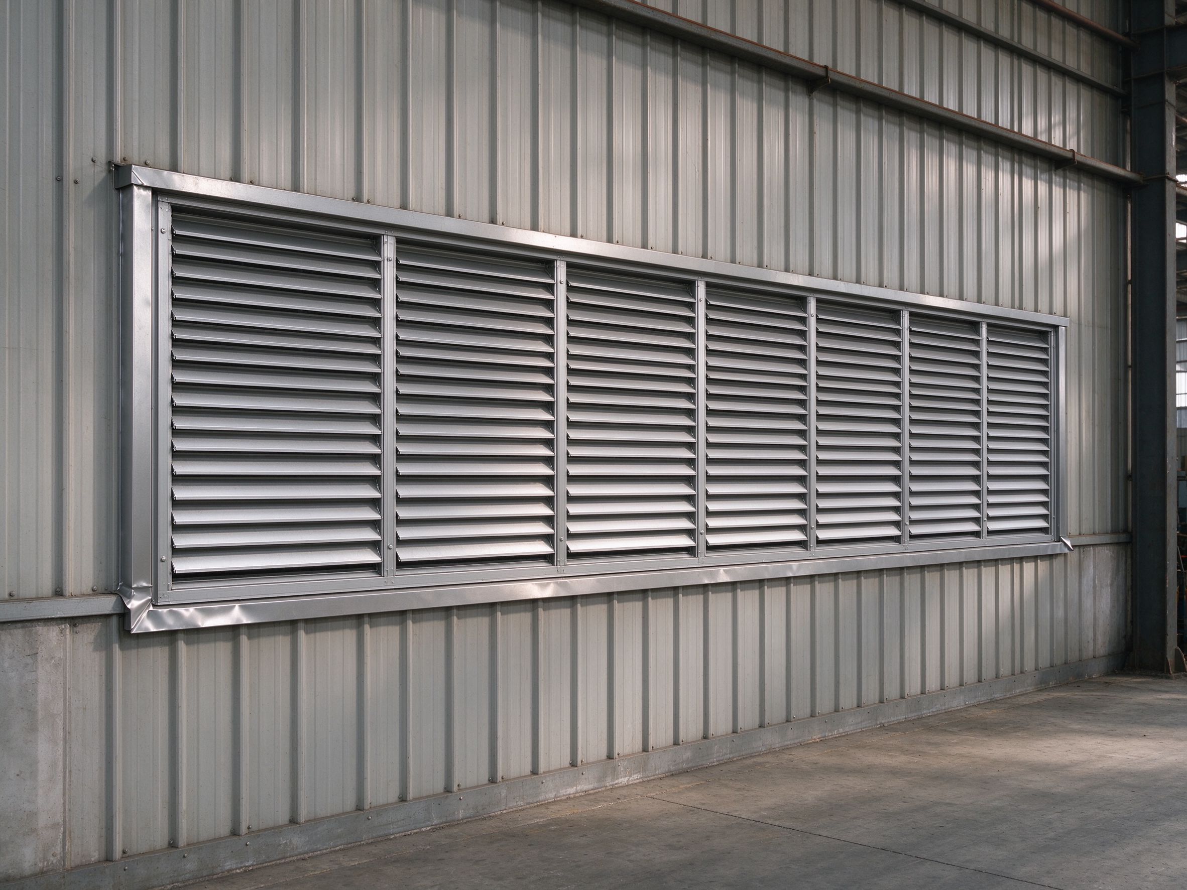 Side-wall louvered ventilators on a steel building (illustrative concept image)